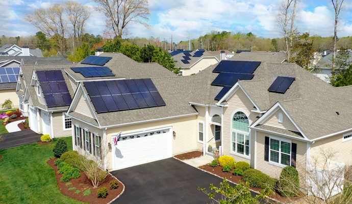 overhead view of neighborhood and house with solar panels on roof 98771